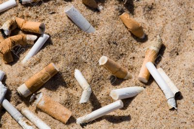 Cigarette butt in sand Cigarette butt in sand