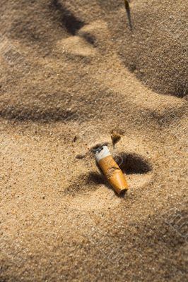 Cigarette butt in sand Cigarette butt in sand