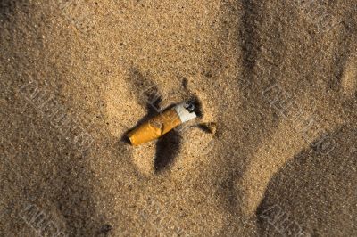 Cigarette butt in sand Cigarette butt in sand