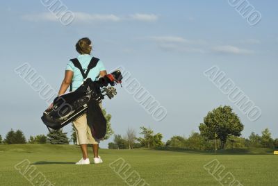 Woman Golfer Carrying Golf Clubs