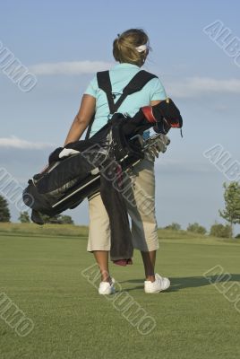 Woman Golfer Carrying Golf Bag