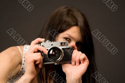 Playful girl photographer, focus on camera