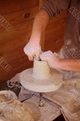 potter makes pitcher