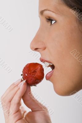 Biting into a strawberry