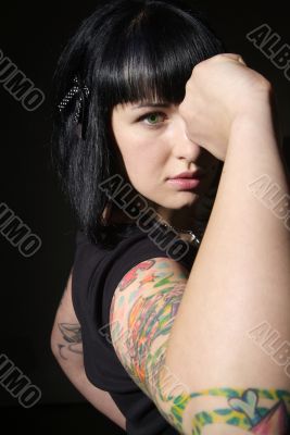 woman with tattoo and fist