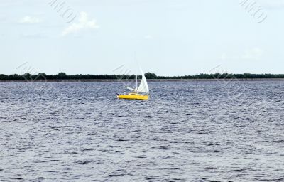 sunny sailboat in windy blue ocean