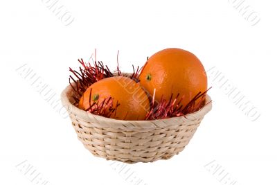 Wum basket with ripe oranges on a white background Wum basket with ripe oranges on a white background