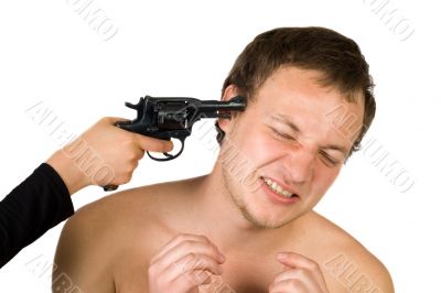 The young man with a pistol at a head. isolated