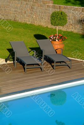 deck chairs in front of pool deck chairs in front of pool