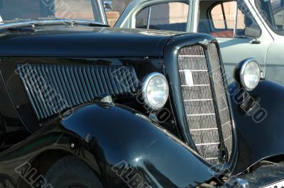 Forward part of the old automobile. A cowl and headlights.