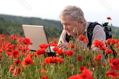 Photographer in poppy field