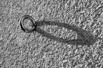 Metal - hook, eyelet in a wall.