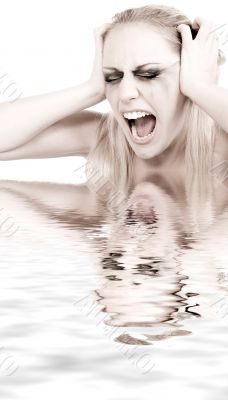 Studio portrait of a young blond woman in despair