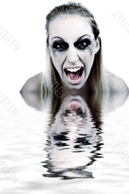 Studio portrait of a young blond woman in horror