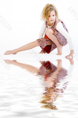 Blond child stretching her leg