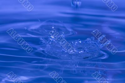 splash of blue water with small drops