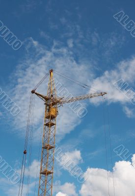 Lifting construction crane at blue sky