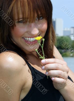 Young woman with a yellow flower.