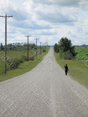 person walking on a dirt road