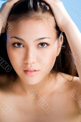 beautiful asian woman on blue background