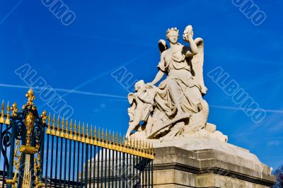 Statue at a gate in Versailles Statue at a gate in Versailles