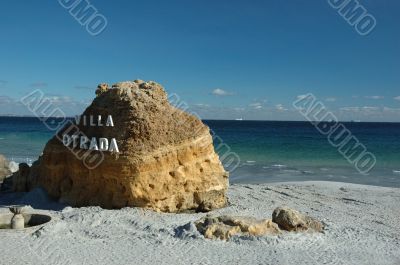 Big yellow rock on the uninhabited public beach