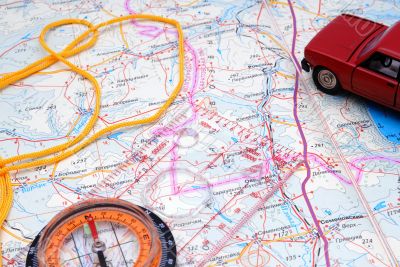 Fragment of a map with a compass and model of the automobile