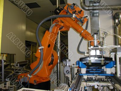 Orange robot standby for next work process.
