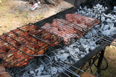 Preparing meat barbecue upon open fire