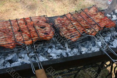 Preparing meat barbecue upon open fire