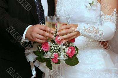 hands of newlyweds with champagne cups