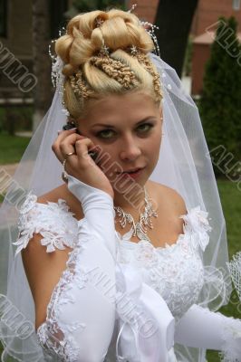 Young bride with cell phone