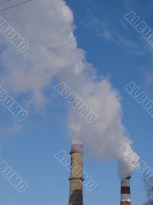 cloudscape with smoking industrial pipes