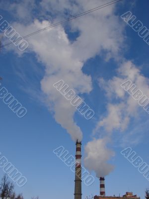 cloudscape with smoking industrial pipes