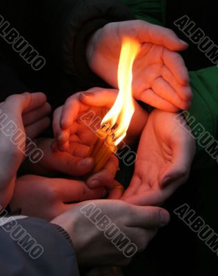 Flaming candle upon palms protection Flaming candle upon palms protection