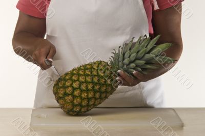 Woman Cutting Pineapple