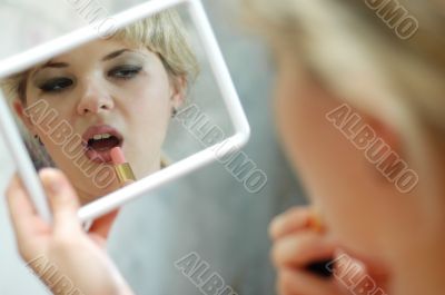 Woman with lipstick and mirror