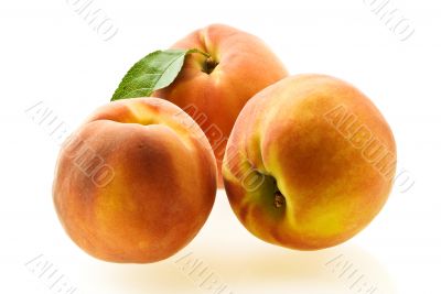 three ripe fresh peaches