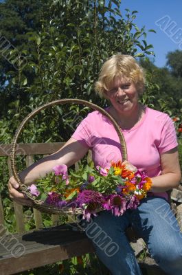 elderly woman just picked a bunch of flowers