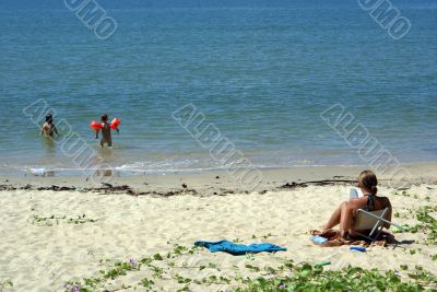 Woman and kids on the beach