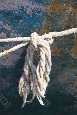 Detail of frayed rope on side of boat
