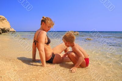 ma and son on beach on background blue sky 2