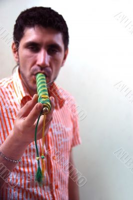 drug addict with tube marijuana at the wall