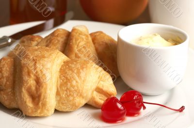 Breakfast plate with croissants and cherries