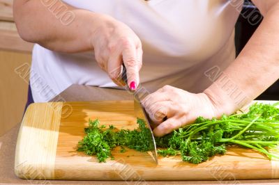 Woman chopping food in kitchen