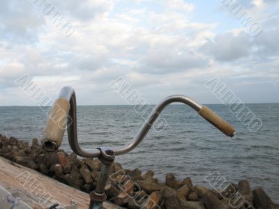 old bicycle on the side of the ocean