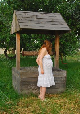 The pregnant girl at a well