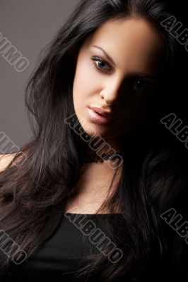 brunette girl posing on dark background