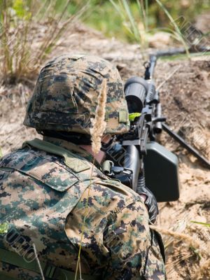 Soldier shooting his machine gun