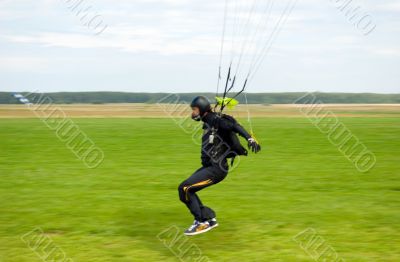 Landing of the sportsman after parachute jump